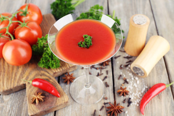 Tomato juice in goblet and fresh vegetables