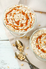 Tasty dessert with oat flakes, on table