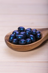 Cod liver oil omega 3 gel capsules isolated on wooden background