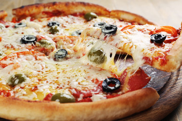 Pizza with cheese on board and wooden table background
