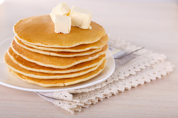 Stack of delicious pancakes with butter