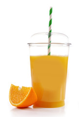 Orange juice in fast food closed cup with tube and slice of