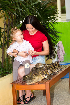 Mom and child girl on Crocodile farm in Phuket, Thailand