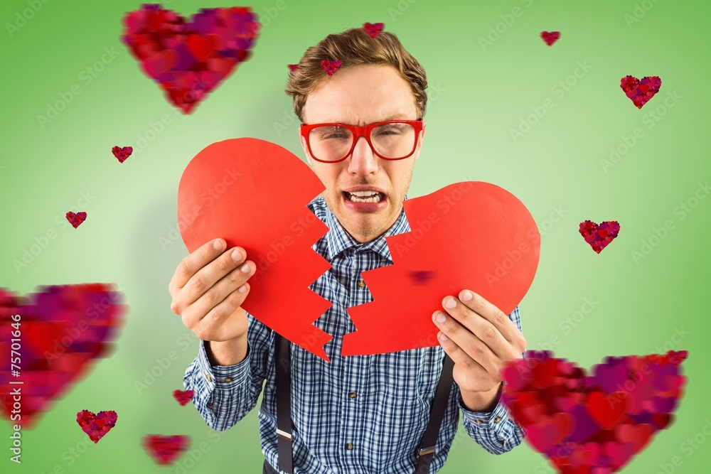Poster Composite image of geeky hipster holding a broken heart
