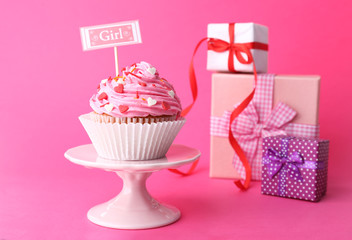 Delicious cupcake with inscription on pink background