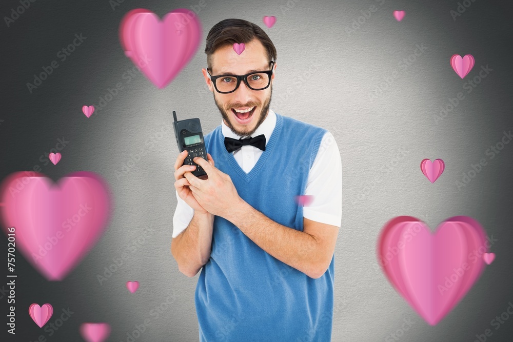 Aufkleber composite image of geeky hipster holding a retro cellphone