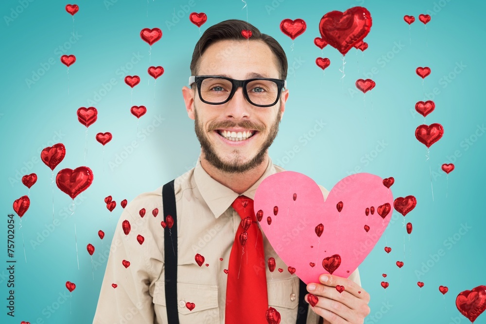 Aufkleber Composite image of geeky hipster smiling and holding heart card