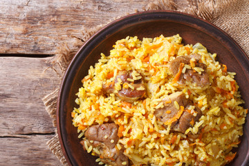 Rice with meat and vegetables closeup. horizontal top view