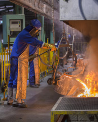 operator pouring automotive part