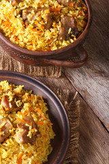 pilaf with meat and vegetables closeup vertical top view