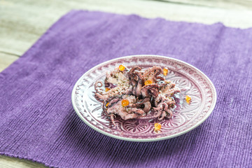 Small octopuses decorated with red caviar