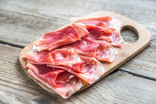 Slices of jamon on the wooden board