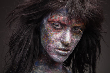 girl in paint and neon powder with glitter