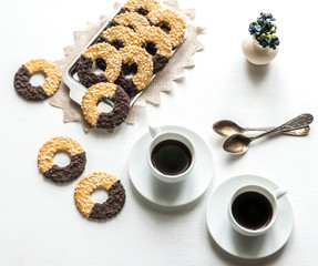 Chocolate cookies with two cups of coffee
