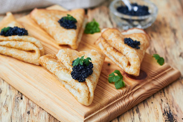Pancakes with black caviar