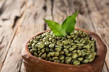 green coffee beans in wooden bowl