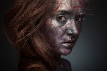 Obraz premium Beautyful girl with silver and violet glitter on her face