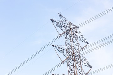 View side of high voltage poles in blue sky