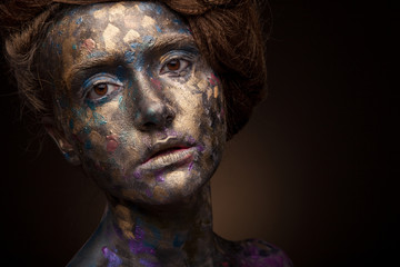 Beautyful girl with gold and grey glitter on her face. Portrait