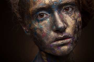 Beautyful girl with gold and grey glitter on her face. Portrait