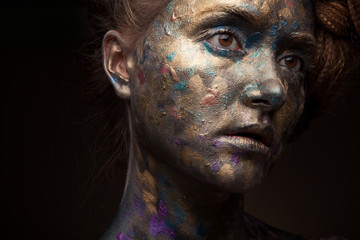 Beautyful girl with gold and grey glitter on her face. Portrait