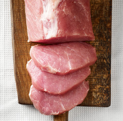 fresh raw meat on wooden cutting board