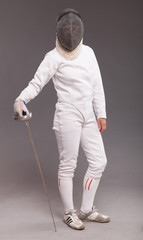girl in white fencing costume. with sword and  fencing mask 
