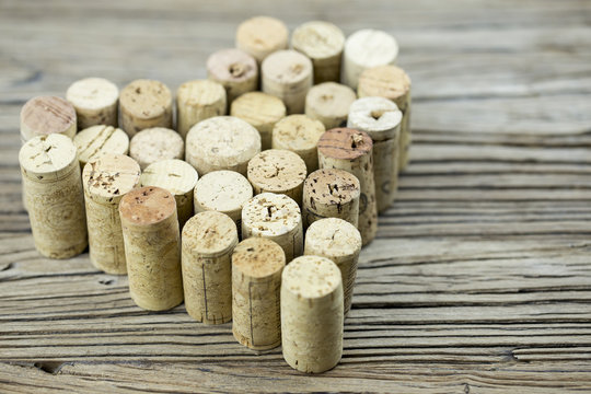 Wine corks form a heart shape on the wood board background