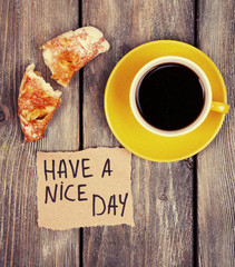 Composition of coffee, fresh croissant and paper card