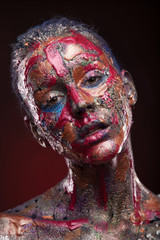 Portrait of girl in paints. Body art and face art