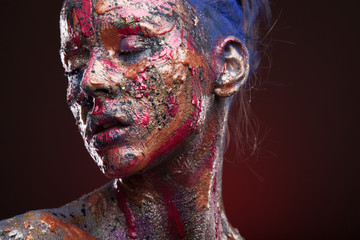 Portrait of girl in paints. Body art and face art