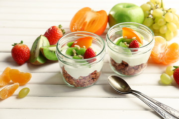 Healthy dessert with muesli and fruits on table