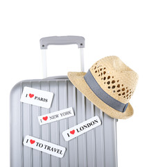 Travel suitcase and hat isolated on white