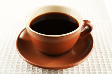 Cup of coffee on white napkin background