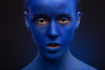 art photo of a beautiful woman with blue face