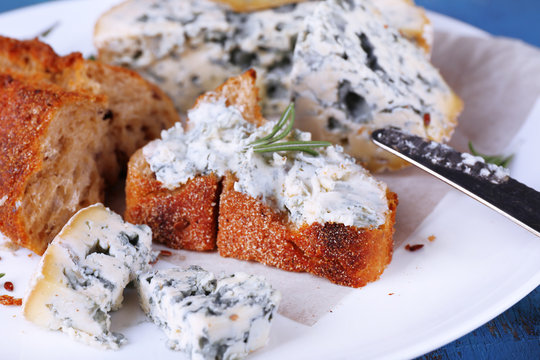 Blue cheese with sprigs of rosemary, bread and nuts