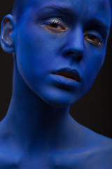 art photo of a beautiful woman with blue face