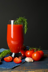 Glass of tasty tomato juice and fresh tomatoes