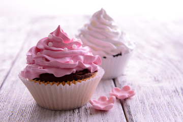 Delicious cupcakes on table close-up