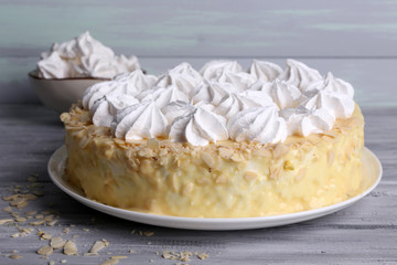 Tasty homemade meringue cake on wooden table