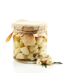 Canned garlic in glass jar, isolated on white