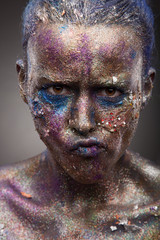 Beautiful face of a woman covered in glitter. Face art. Sexy