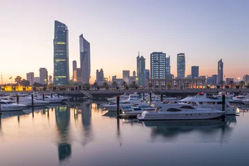 Tuinposter Souk Sharq Marina and Kuwait City at dusk © philipus
