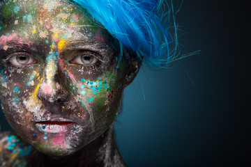 Blue hair. Woman with face art and body art. Painted girl 