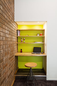 Lime green feature wall study nook in living room