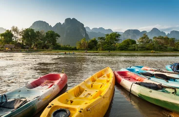 Fotobehang kayak boats in Nam Song river at Vang Vieng, Laos © worldwide_stock