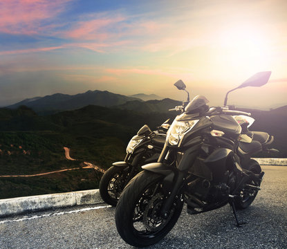 big bike ,motorcycle parking on top of mountain with sun light o