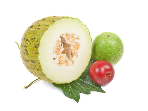 Sliced melon, green apple and  plum isolated on a white