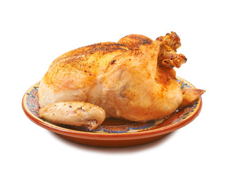 Fried chicken on a plate with pickles on a white background isol