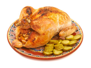 Fried chicken on a plate with pickles on a white background isol